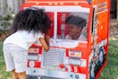 kids playing in a melissa & doug fire truck