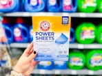 In-store photo of Arm & Hammer Power Sheets held up in laundry aisle at Walmart