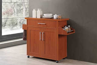 A kitchen island in a hallway of a home.