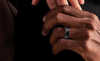 a hand with a smart ring on the finger