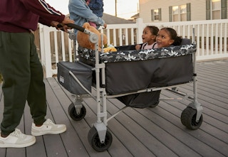 kids sitting in a stroller wagon