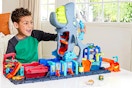 Lifestyle image of the Hot Wheels City Ultra Shark Car Wash playset (little boy playing in home)