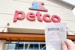 a person holding up at petco receipt outside of petco