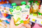 hand holding beech-nut baby food pouches