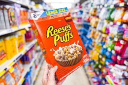 hand holding reese's puffs cereal at dollar general