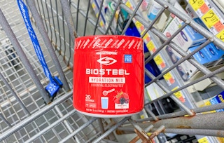 bright red can of biosteel hydration mix in a walmart cart with walmart aisle slightly visible in the background