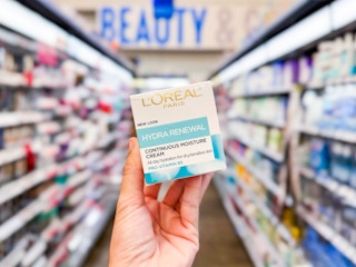 L'Oreal Paris Hydra-Renewal Continuous Facial Moisturizer held up in center aisle at Walmart
