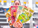 woman holding four coloring books in walmart aisle