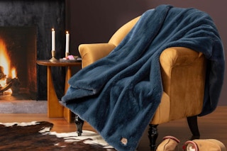 UGG Plush Faux Fur Throw Blanket on a living room chair.