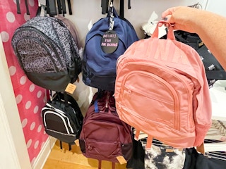 hand holding Victoria's Secret backpack