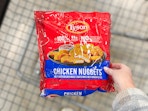 hand holding a bag of tyson chicken