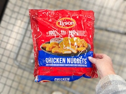 hand holding a bag of tyson chicken
