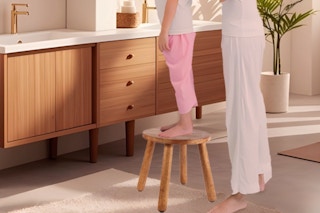 a girl standing on a step stool