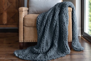 a chunky knit throw on a chair 