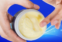hands holding a jar of magnesium cream