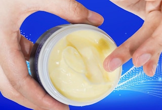 hands holding a jar of magnesium cream