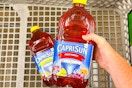 hand holding a bottle of capri sun