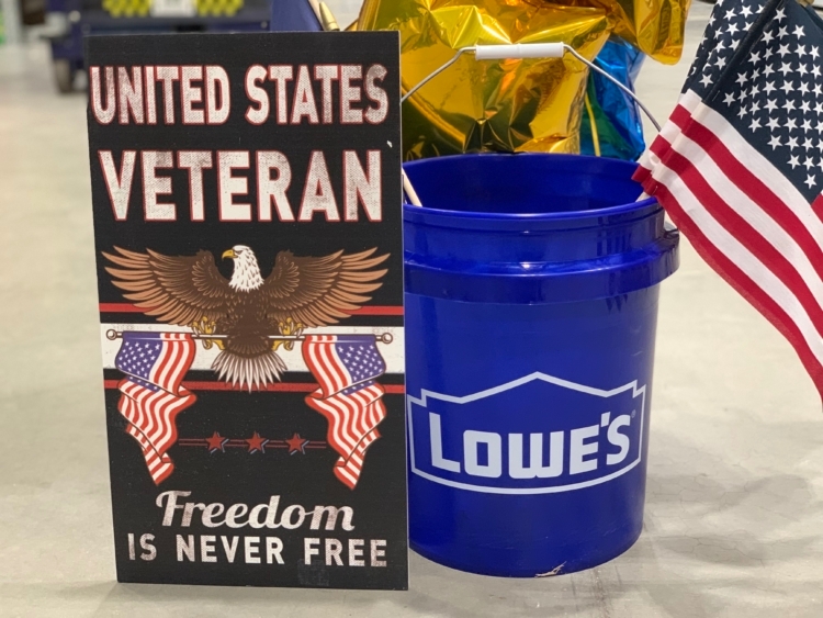 veteran sign with lowe's bucket full of american flags