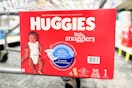 box of huggies diapers on the bottom of a cart