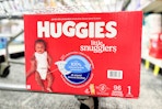 box of huggies diapers on the bottom of a cart