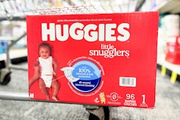 box of huggies diapers on the bottom of a cart