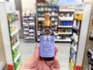 hand holding sheamoisture hair oil in walgreens