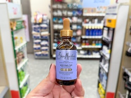 hand holding sheamoisture hair oil in walgreens