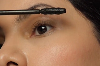 a woman applying e.l.f. lash it loud mascara