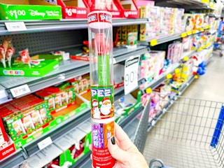 hand holding christmas pez set in walmart aisle