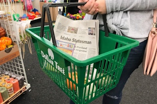 someone holding dollar tree basket with paper in it