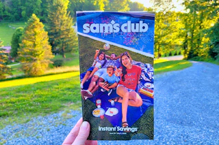 hand holding sams club instant savings book june 2026