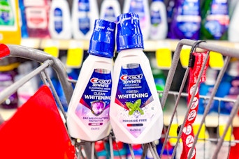 2 bottles of crest 3d white mouthwash in a cart