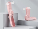 a pink foldable fan on display