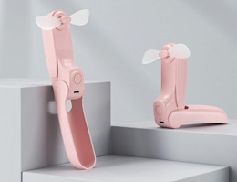 a pink foldable fan on display