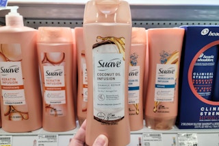hand holding a bottle of suave shampoo at kroger