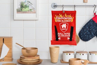 a fire blanket on hooks in a kitchen 