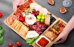 a bamboo charcuterie board full of food