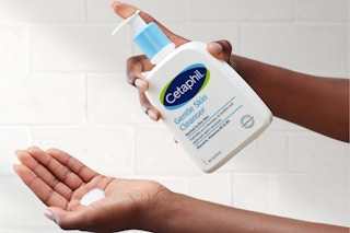 a hand holding up the Cetaphil Face Wash, Gentle Skin Cleanser