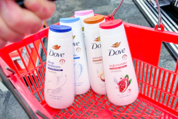 person holding a red basket with 5 bottles of dove body wash in it