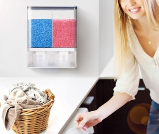 a laundry bead dispenser on the wall near a laundry basket next to a person