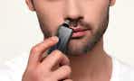 a person using a nose hair trimmer