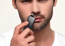 a person using a nose trimmer