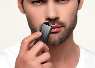 a person using a nose hair trimmer