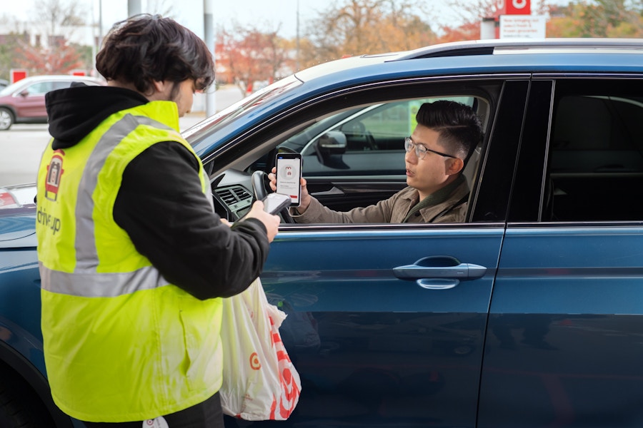 A person showing their phone to the employee at the Target Drive Up