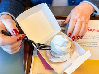 about to eat a cinnamon roll with ice cream on top