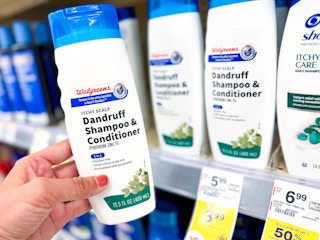 hand holding walgreens brand dandruff shampoo