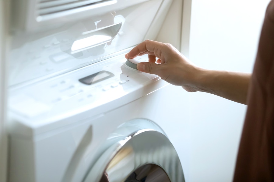 adjusting dial on washing machine