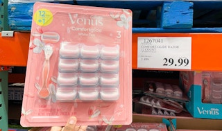 razor hand held near sale sign at costco