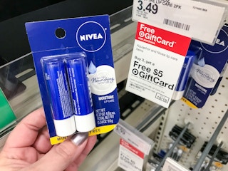 hand holding nivea lip balm 2-pack in front of target gift card tag