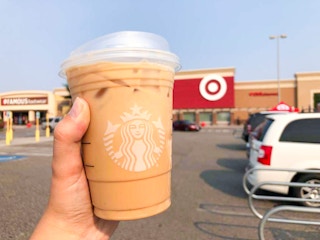 hand holding a starbucks iced beverage outside of target